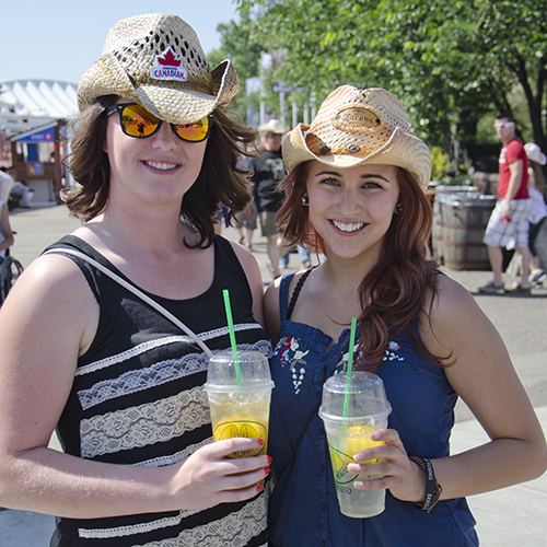 Two girls with cowboy hats holding Lemon Heaven lemonade